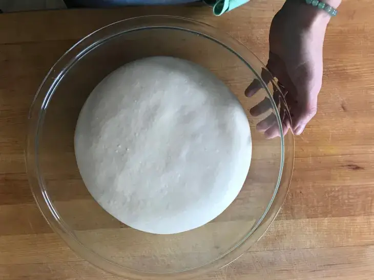 bring the pizza dough to room temperature