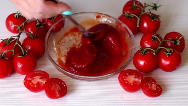 combining tomato paste and sauce