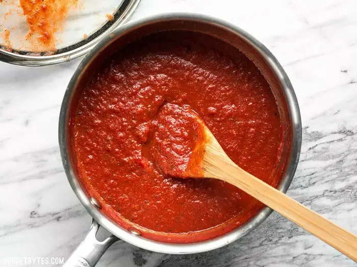 preparing the pizza sauce