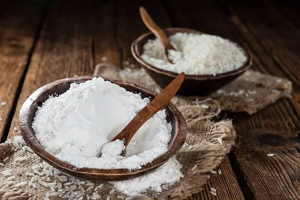 Portion of Rice Flour on vintage wooden background